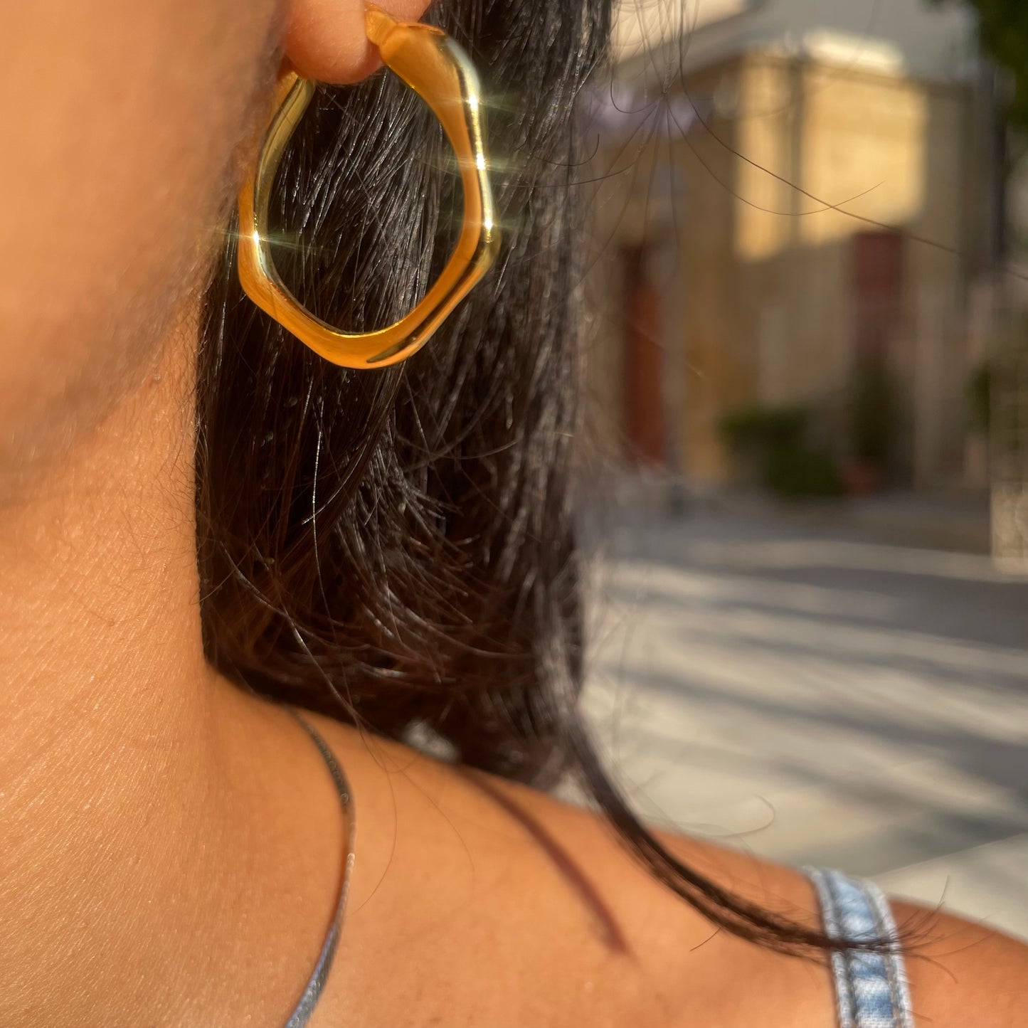 Gold asymmetric hoop earrings