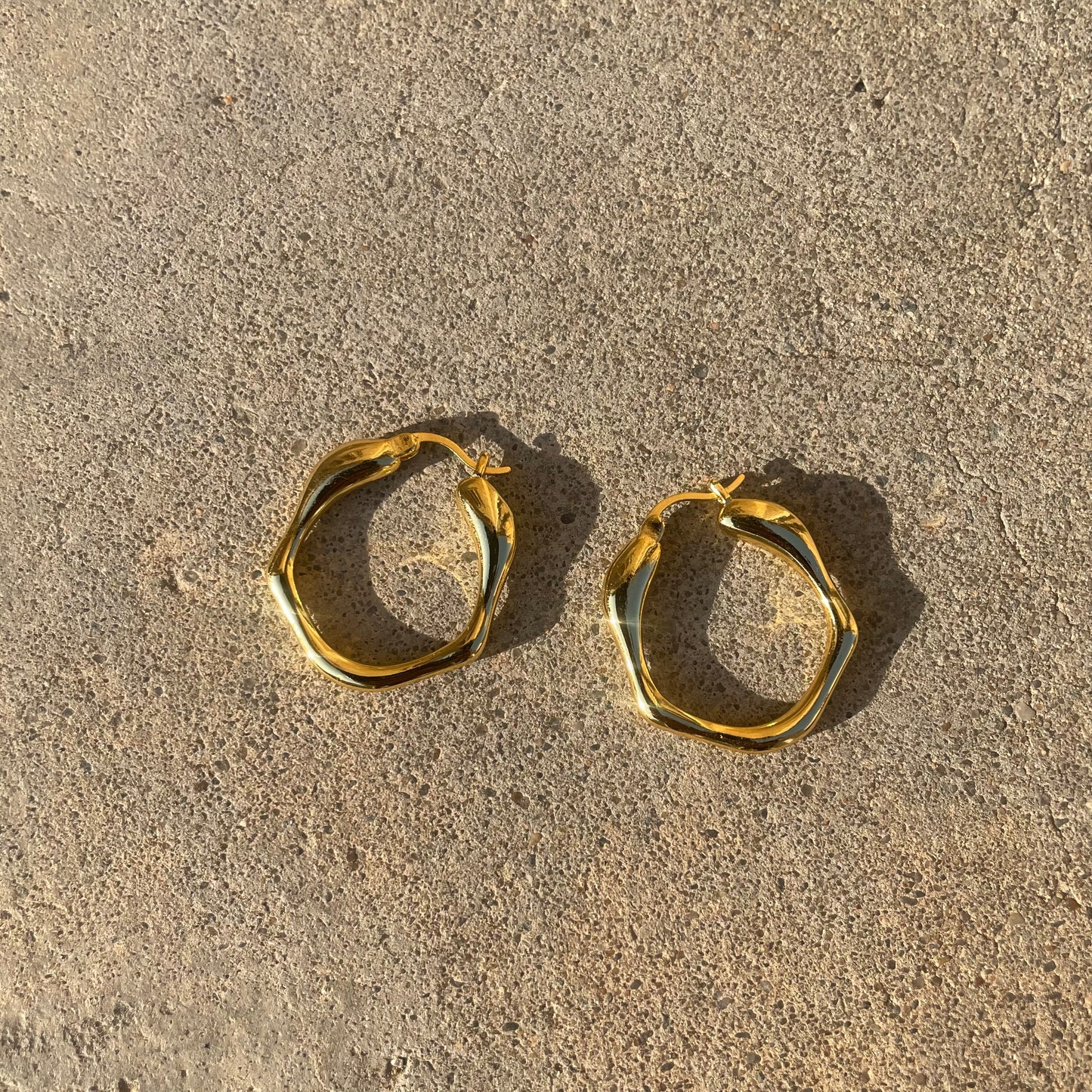 Gold asymmetric hoop earrings